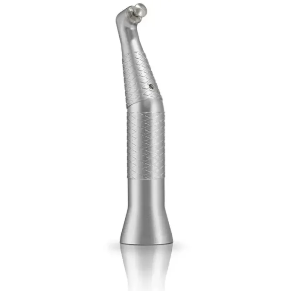 Silver dental handpiece (drill) with knurled grip, standing on a reflective surface used by dentists for tooth drilling and preparation.